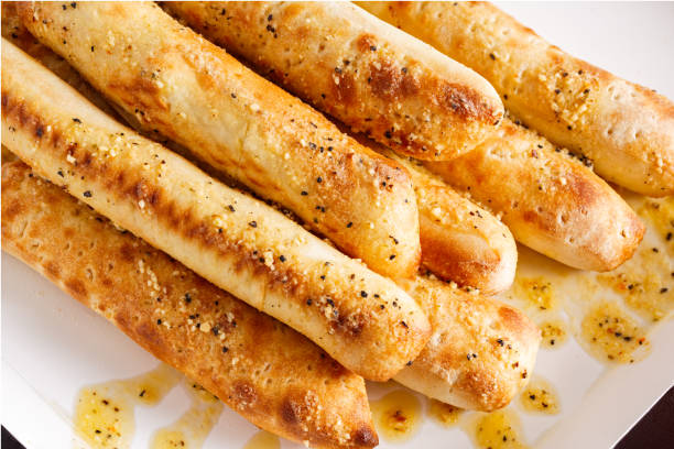 Bread Sticks Bread sticks seasoned with butter and herbs breadstick stock pictures, royalty-free photos & images