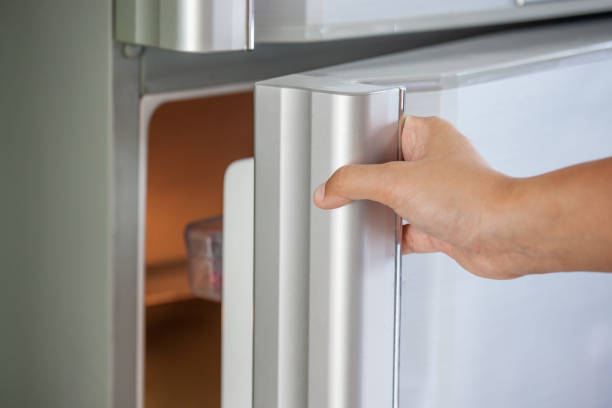 istock Woman hand opening a refrigerator door 804867610