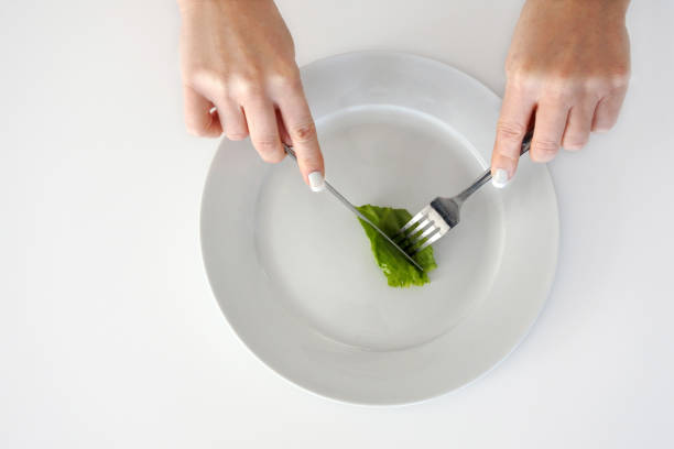 istock Woman hands eating piece of lettuce 804867888