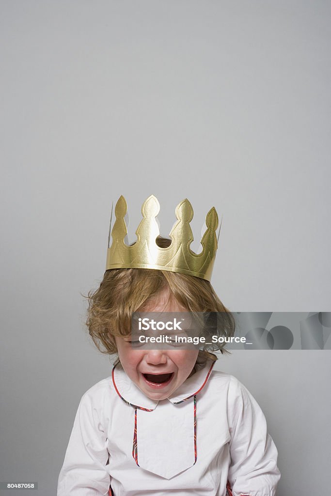 Boy in a party hat having a tantrum   Crown - Headwear Stock Photo