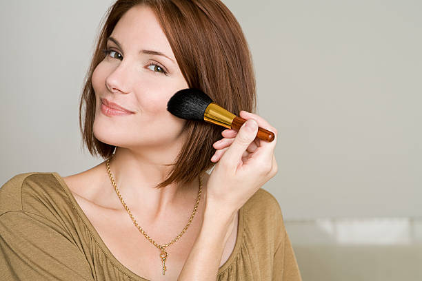 Woman applying makeup  blusher make up stock pictures, royalty-free photos & images