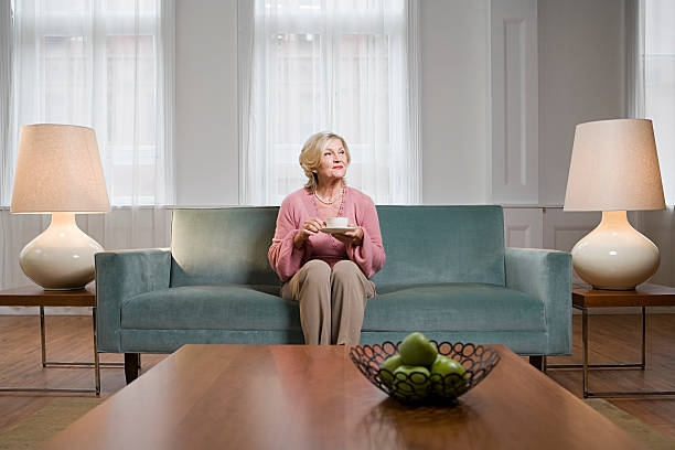 Woman in living room  only senior women stock pictures, royalty-free photos & images