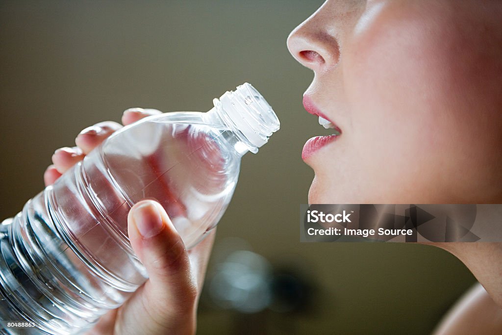 A woman holding a bottle of water  Active Lifestyle Stock Photo