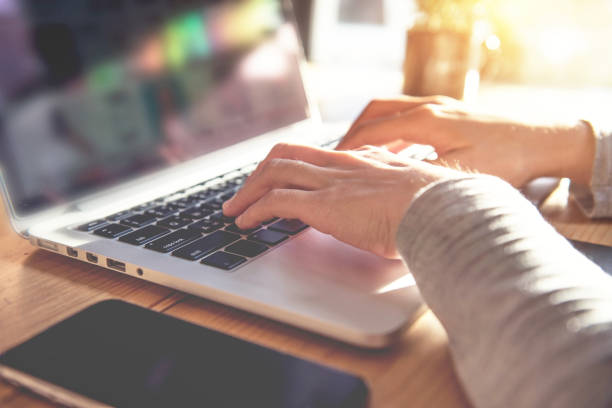istock Closeup woman's hands typing on a laptop 804906628