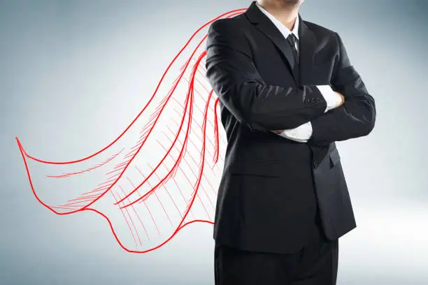 Photo of Businessman with drawn red color cape. the concept of success, leadership and victory in business.