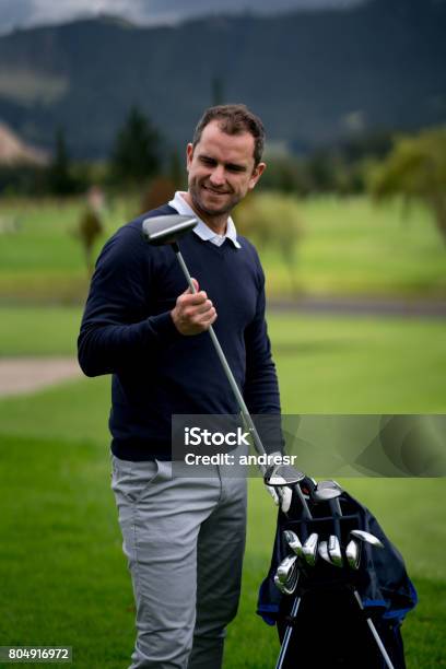 Man Playing Golf And Choosing The Club Stock Photo - Download Image Now - 40-49 Years, Active Lifestyle, Adult