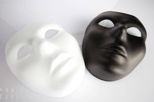 istock Black and white masks on white surface  - looking upwards 804919810