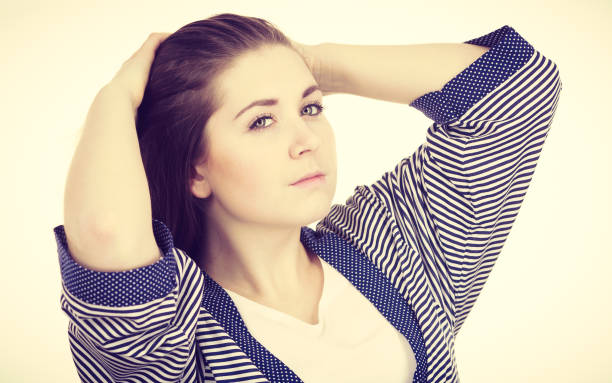 istock Young woman touching her long brown hair 804928708