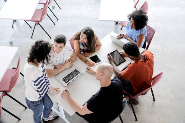 Meeting Education and Technology Group of people gathering to learn and teach, discussing a subject in the meeting. reunion social gathering stock pictures, royalty-free photos & images