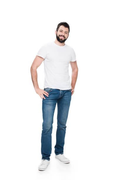 istock Bearded young man in white t-shirt standing with hands on hips and smiling at camera 804934782