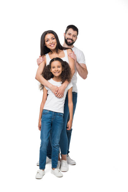 smiling multiethnic family standing and looking at camera together isolated on white - multi ethnic group family child standing imagens e fotografias de stock