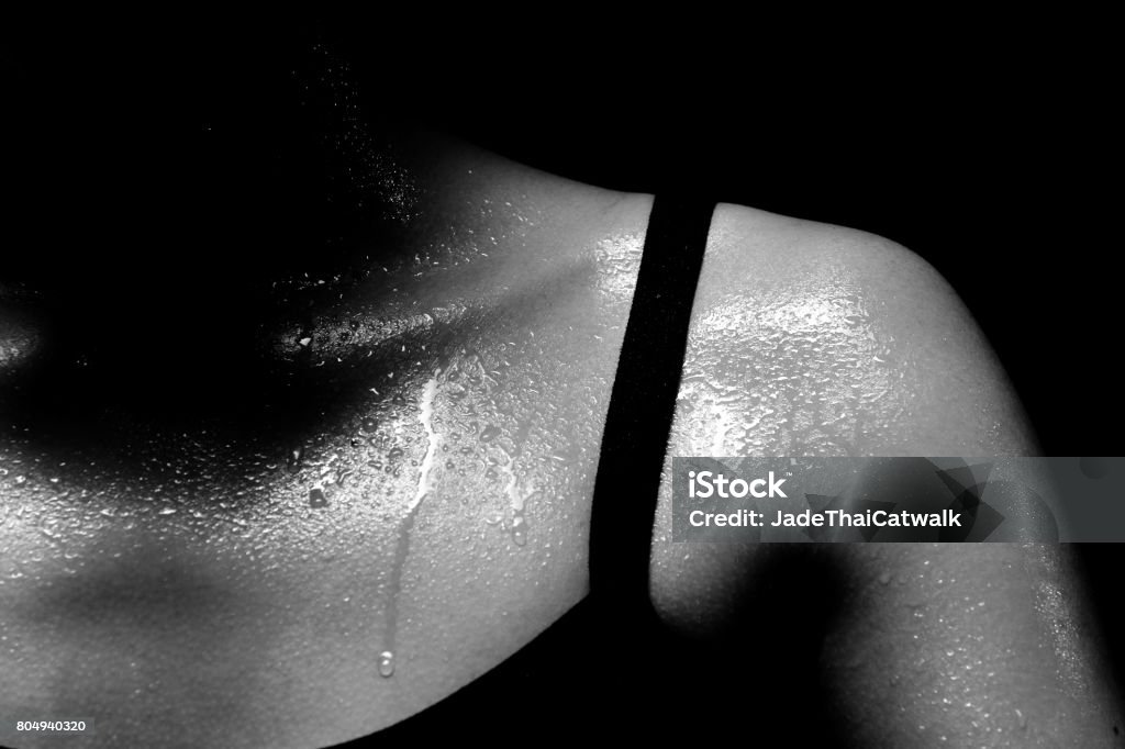 Fitness Woman, Girl Can do Strong Asian Tan Skin Sport Girl in Fitness Bra long black pants, exercise sweat water drop in low key exposure lighting. black white concept no retouch, shoulder part Sweat Stock Photo