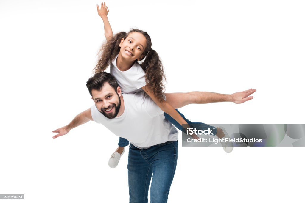 father and daughter piggybacking and looking at camera isolated on white Father Stock Photo