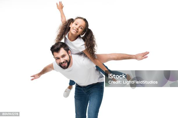 Father And Daughter Piggybacking And Looking At Camera Isolated On White Stock Photo - Download Image Now