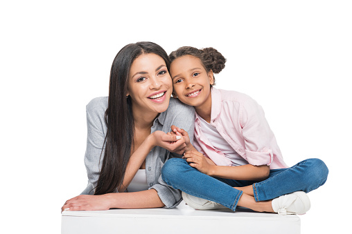 portrait of happy mother and daughter looking at camera isolated on white