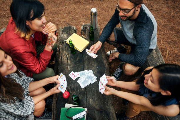 istock Friends Camping Playing Cards Concept 804947432