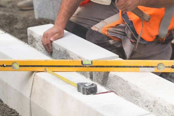 istock Construction worker leveling concrete pavement outdoors. 804952588