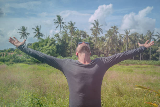 istock Man with arms wide open enjoying in nature. 804960490