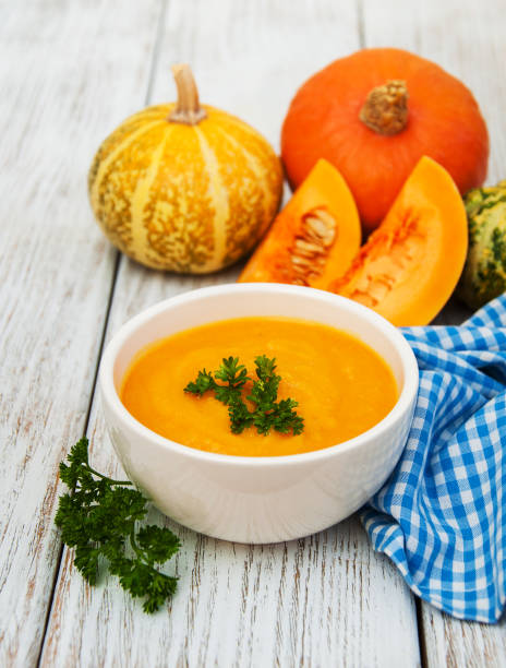 istock Pumpkin soup with fresh pumpkins 804968048