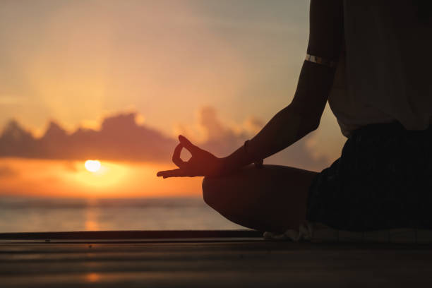 istock Woman practicing yoga on the beach. 804970988