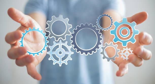 istock Businessman holding hand-drawn gears icons 804982980