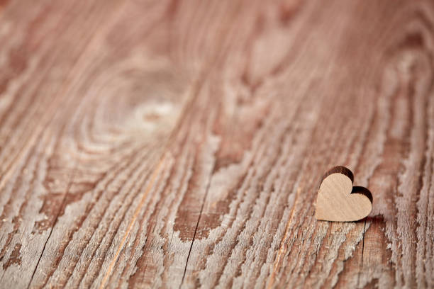Little heart figure on wooden background