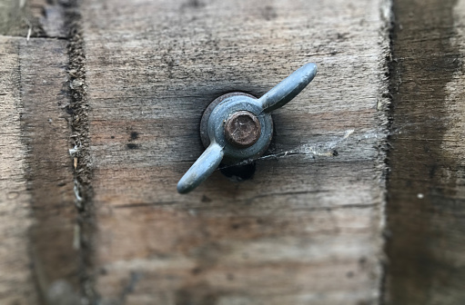 Silver rusty old Industrial screw nut and bolt. Selective focus.