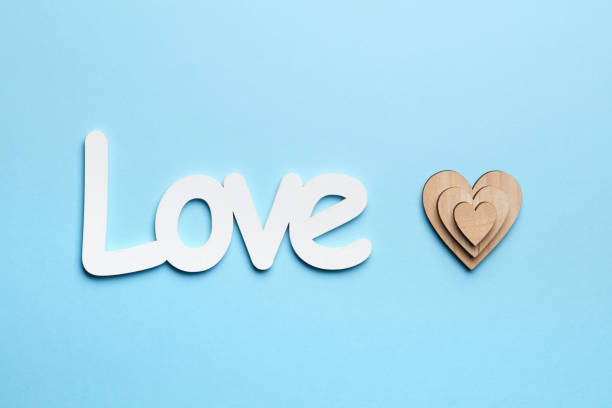 istock Wooden hearts on blue background with love 804997872