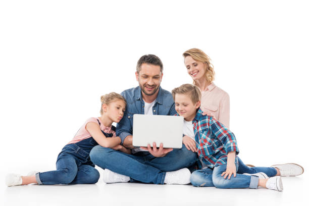 istock smiling family using laptop while sitting on floor isolated on white 804998462