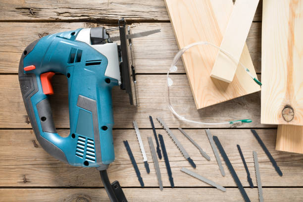 istock Electric jigsaw with blades on wooden table 805001662
