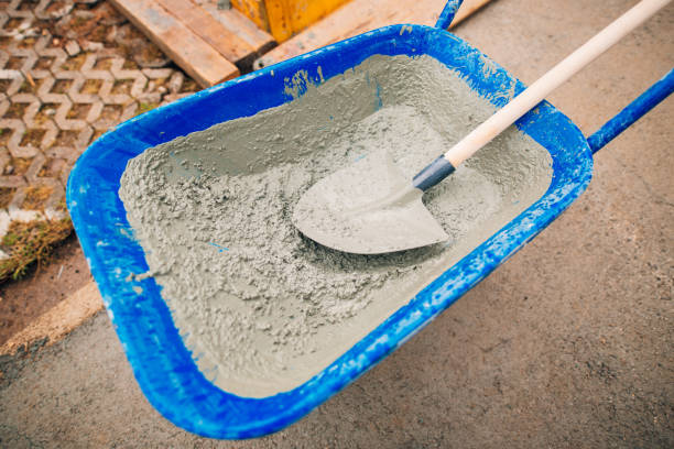 istock Blue clean new wheelbarrow for cement. Laying the first shovel c 805008098