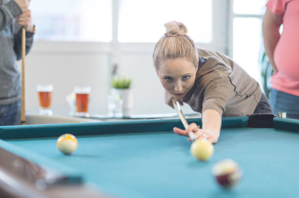 istock Friends hang out and play some pool together 805008424