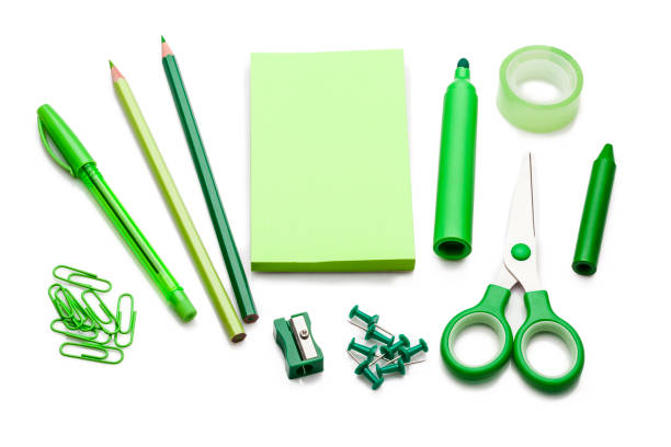 istock Green colored office or school supplies on white background 805009160