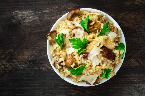 istock Overhead photo of mushroom risotto on rustic texture 805011282