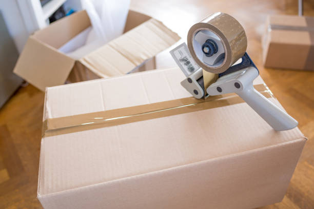 istock House Moving Concept. Closeup of Man Packing Boxes 805020652