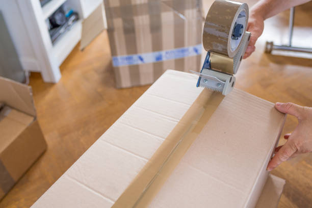 istock House Moving Concept. Closeup of Man Packing Boxes 805020718