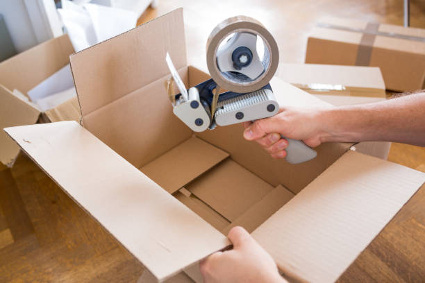 istock House Moving Concept. Closeup of Man Packing Boxes 805020722
