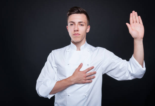 istock Honest cook rising his left hand and swearing 805027094