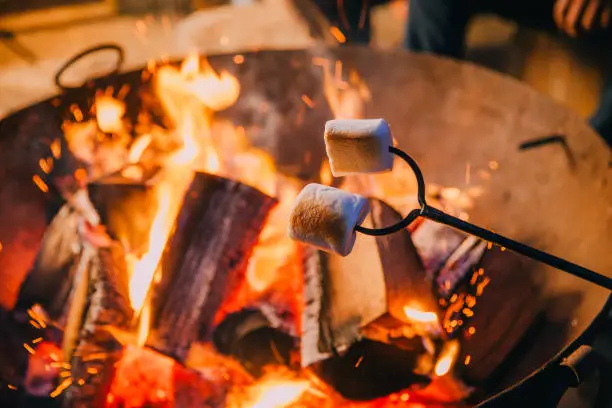 Close-up shot of marshmallows being held over a fire.