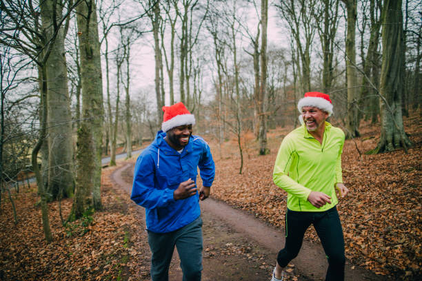 Two Joggers Up the Trails in the Forest at Christmas