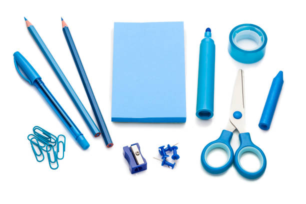 Blue colored office or school supplies on white background High angle view of blue colored office or school supplies isolated on white background. A blank note pad is at the center of the frame with useful copy ready space for text and/or logo. Predominant color is blue. Horizontal DSRL studio photo taken with Canon EOS 5D Mk II and Canon EF 100mm f/2.8L Macro IS USM blue pen stock pictures, royalty-free photos & images