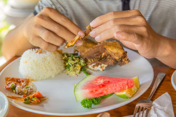 istock Adult men eating crispy fried duck 805042090