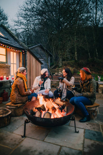 istock Group of Female Friends Gathered Around a Fire Pit 805043192