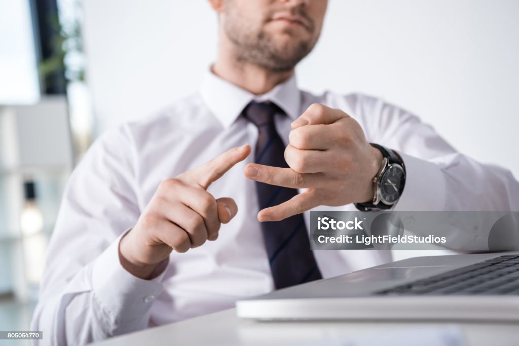 partial view of businessman counting on fingers at workplace, business concept Counting Stock Photo