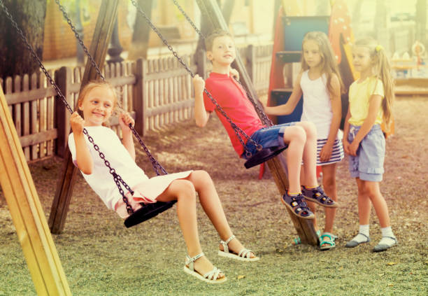 istock Boy and girl on the swing 805071948