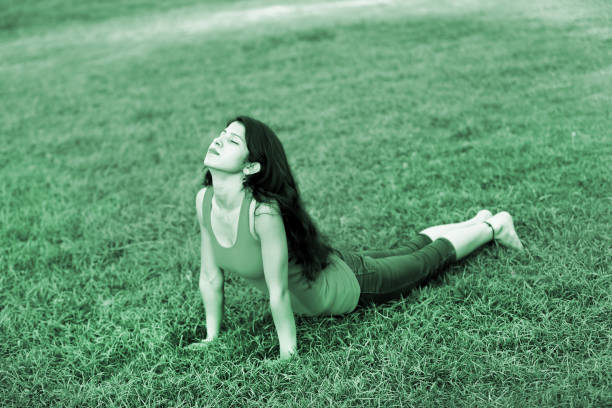 Young beautiful women doing yoga in the park.