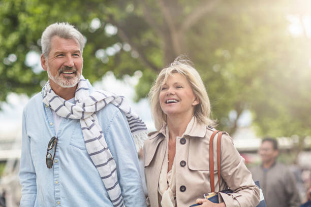 Smiling mature couple walking in city