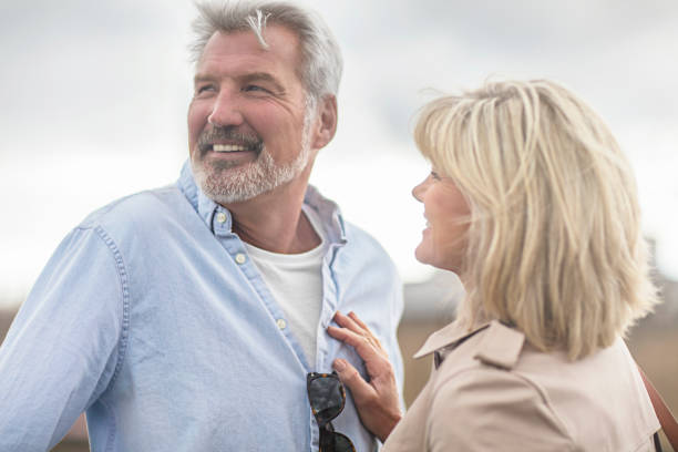 istock Smiling mature couple against sky 805085270