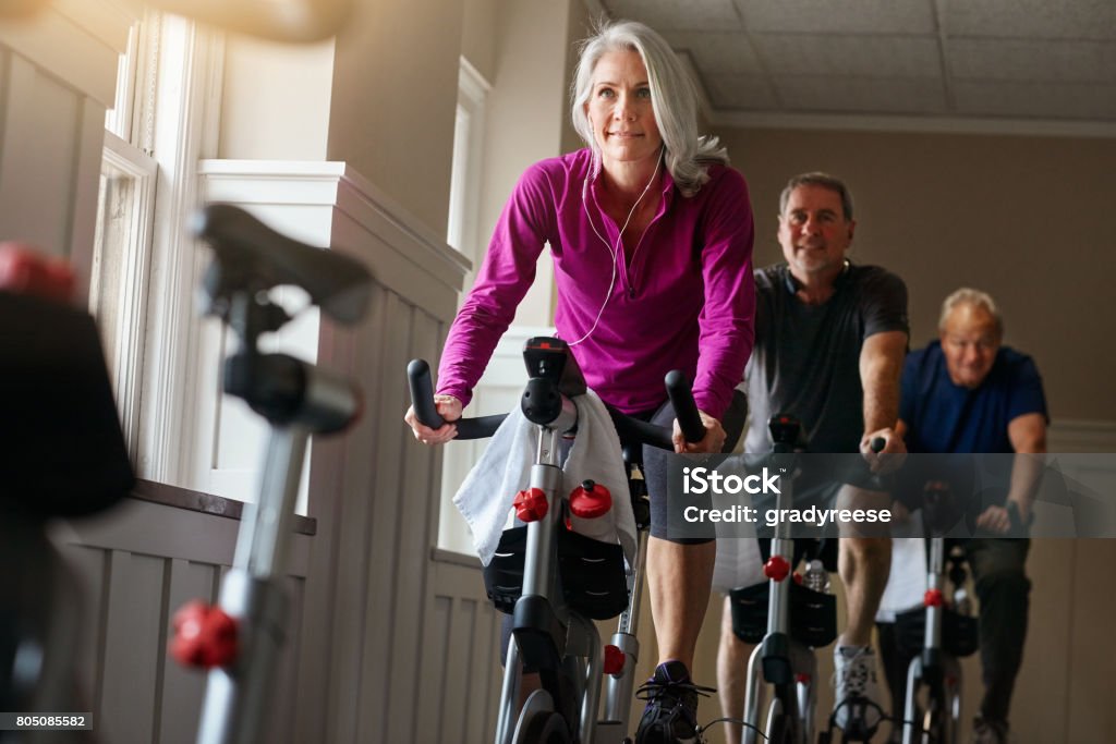 Spin together to win together Shot of a group of seniors having a exercising class at the gym Health Club Stock Photo