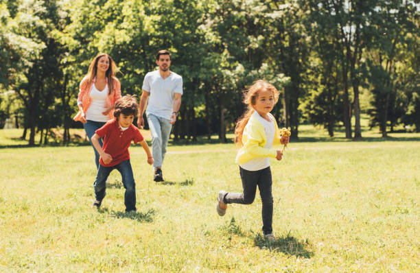 istock Happy family running in the park 805089372